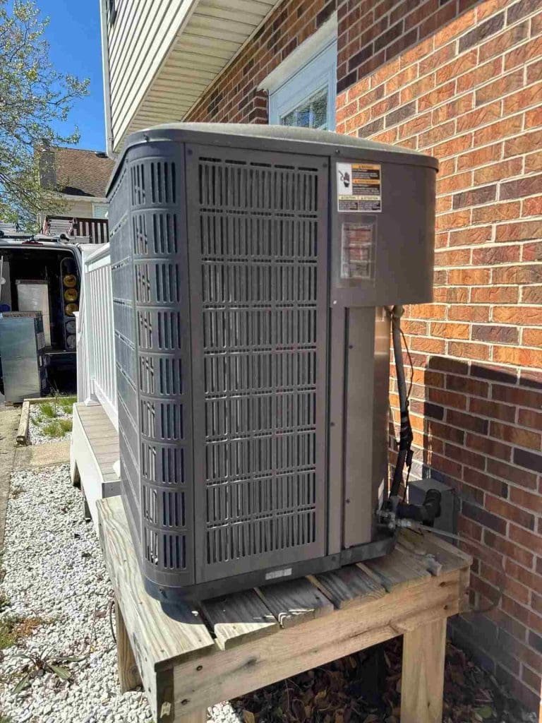 Technician performing spring HVAC maintenance on a Baltimore home