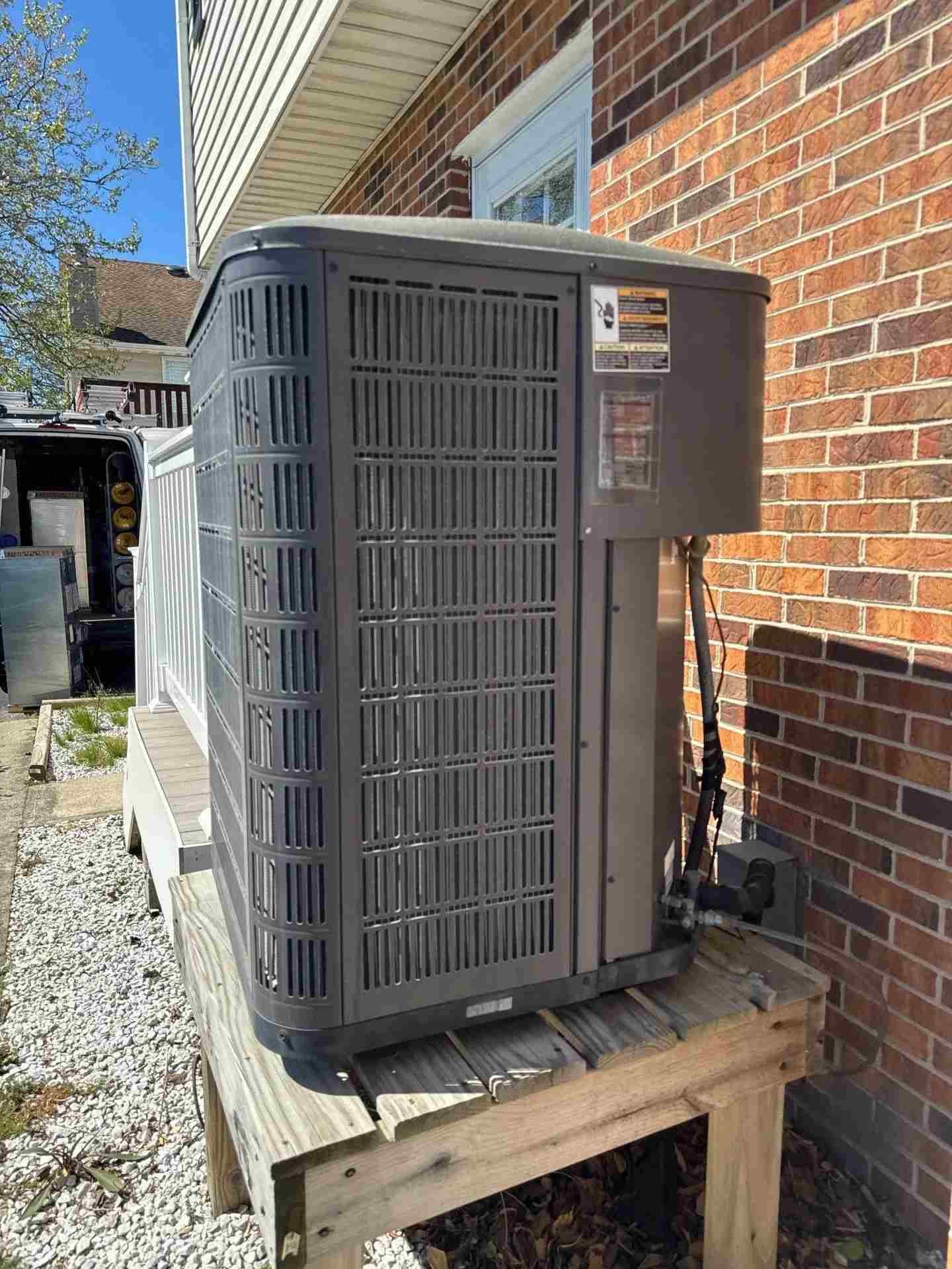 Technician performing spring HVAC maintenance on a Baltimore home
