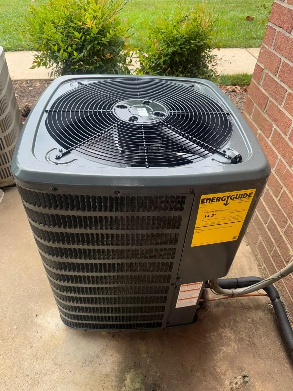 Blog Technician reviewing SEER ratings on a new air conditioning unit